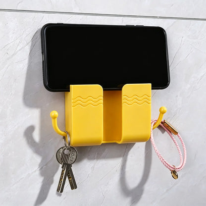 2 Pcs Wall Mount Phone Holder Adhesive Wall Phone Mount Charging Stand and Remote Control Stand Multipurpose Socket Pocket Universal Deck Storage Box for Bedroom, Kitchen, Bathroom, Office